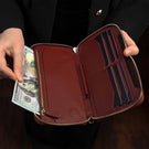 Von Baer W2 large modern leather women’s purse wallet - red - front view in the hand of female model with cash.