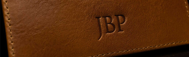 Von Baer wallet embossing personalization example on tan leather.
