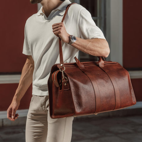 von baer weekender luxury and durable mens leather bag brown with shoulder strap carried by businessman