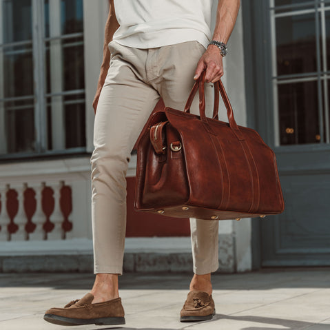 von baer weekender luxury mens leather bag brown made from durable veg tanned leather carried by businessman