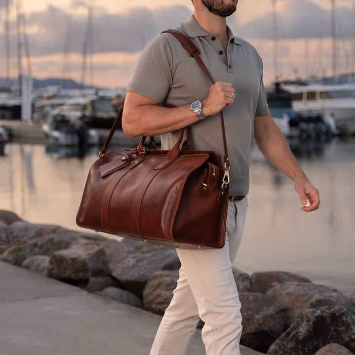 von baer weekender mens leather full grain weekend bag carried by man in luxury marina