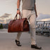 weekender leather bag is carried by the successful man at dock