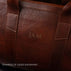 Von Baer Weekender bag in full-grain leather, personalized with laser engraving 'JAM' on the surface.