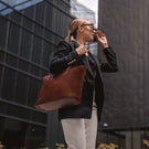 von baer womens elegance large leather tote bag brown with female model in business quarter