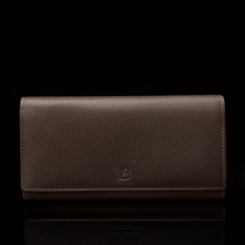 A front view of the W1 Plus dark brown leather wallet with the Von Baer logo.
