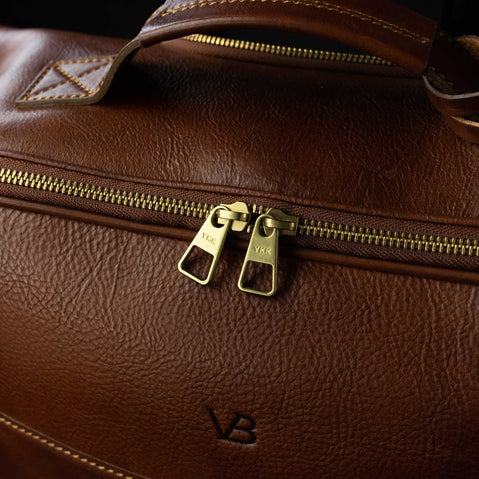 personalized voyager leather carry on bag with wheels for men solid brown YKK zippers close up