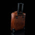 voyager leather carry on bag with wheels for women solid brown back view with telescopic handle